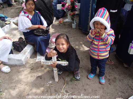 Sisa embraces the grave marker of her birth grandmother