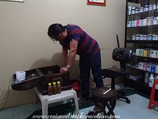 The traditional healer looks into his wooden chest