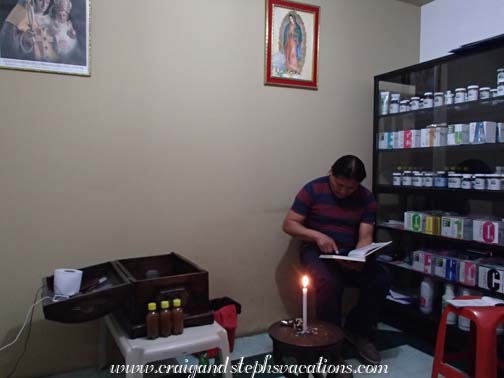 The traditional healer consults his books.