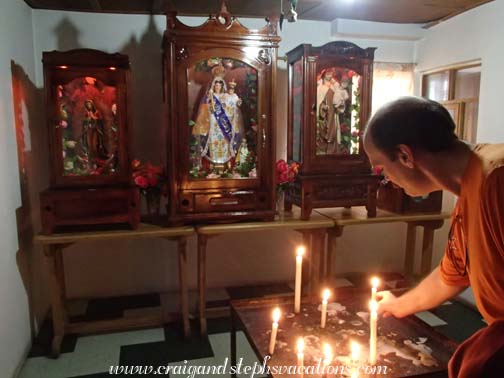 
Craig lights his candle in a shrine following the his appointment with the traditional healer