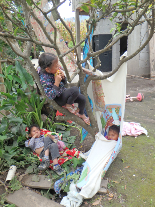 The kids make hammocks out of blankets