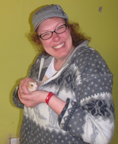 Steph holds a baby guinea pig