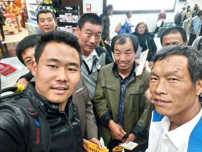 Sonam helps a group of Chinese tourists at Schiphol Airport