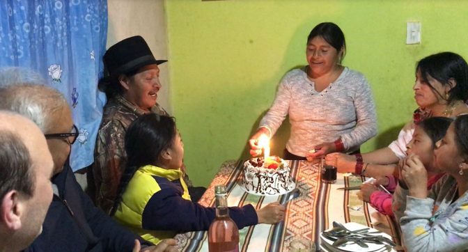 Rosa lights Antonio's birthday candles