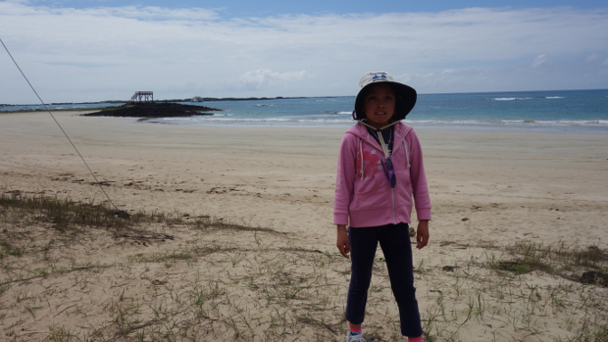 Sisa walking down the beach on Isabela