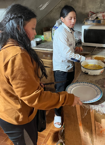 Yupanki cooks breakfast while Sisa sets the table