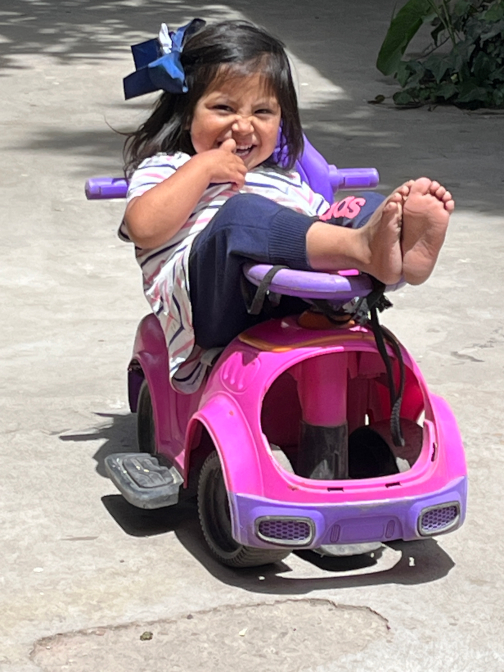 Nena in her plastic car