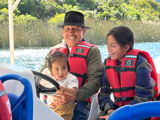 Kuri, Antonio, and Yupanki driving the boat on Lake Cuicocha