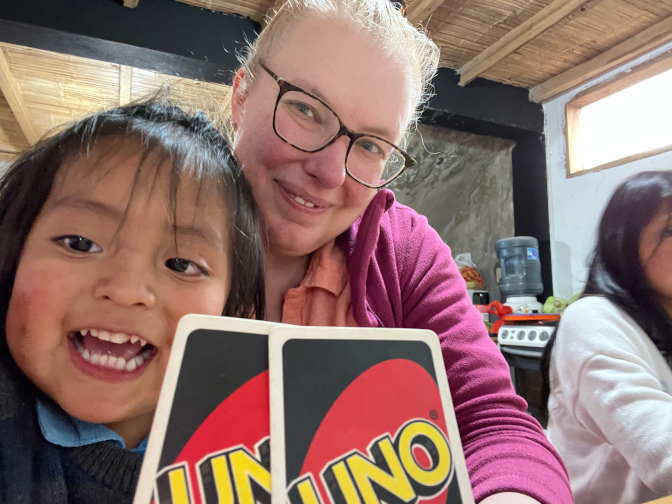 Kuri helps Achi Mama play Uno
