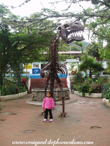 Aracely nervously poses with a dinosaur in the City Park