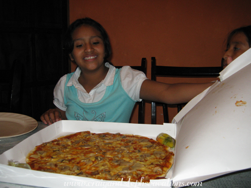 Paola opens the pizza box