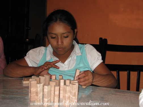 Paola sets up Jenga pieces like dominoes