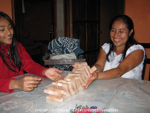 Vanesa and Paulina watch Jenga fall