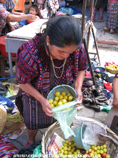 Woman selling us yellow plums