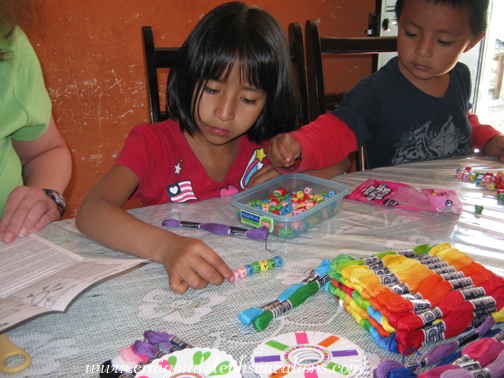 Aracely and Eddy stringing beads