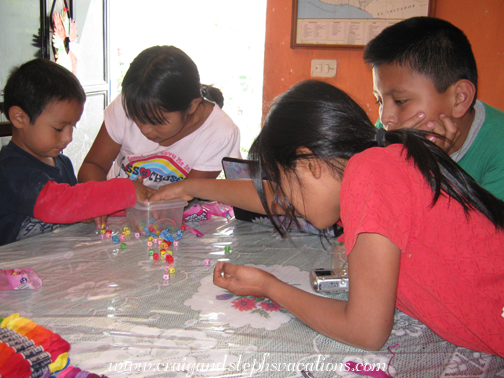 Eddy, Yasmin, Junior, and Yoselin stringing beads