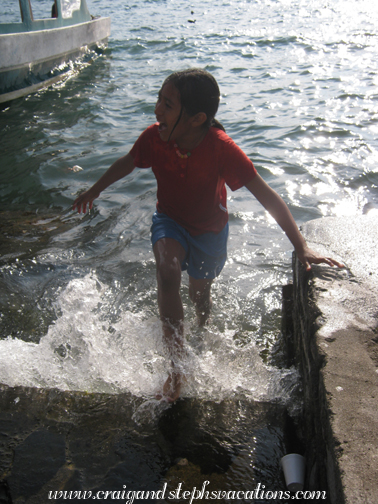 Yoselin gets splashed by waves