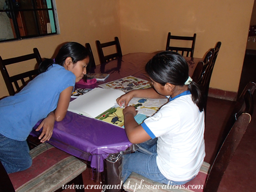 Yoselin and Yasmin play with the sticker books