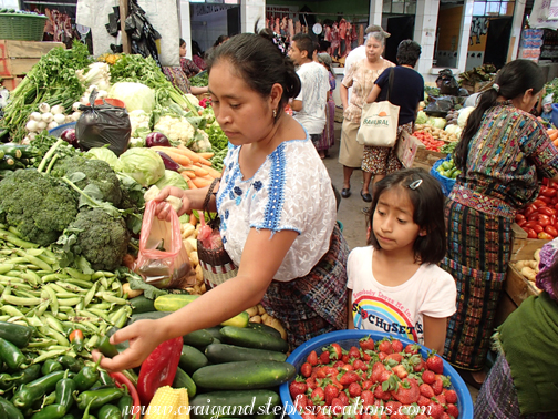 Paulina and Aracely buy produce at the market