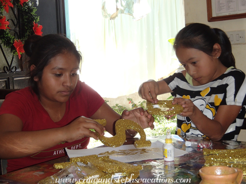 Paola and Loren touch up the decorations