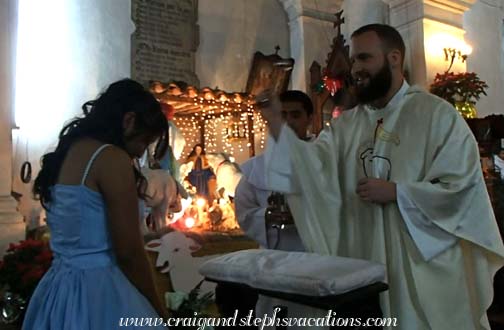 Father Peter anoints Yasmin with holy water