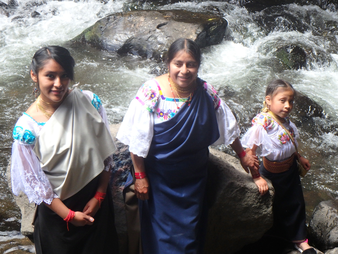 Vanesa, Rosa, and Sisa dip their toes in the river