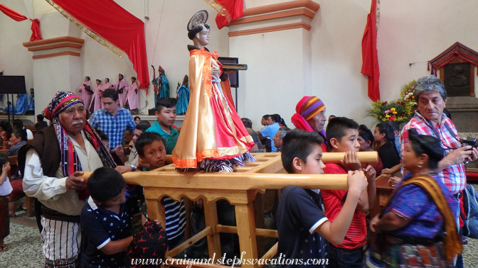 Kids prepare to carry an effigy in the procession