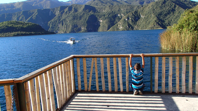 Eddy watches the returning boat on Lago Cuicocha