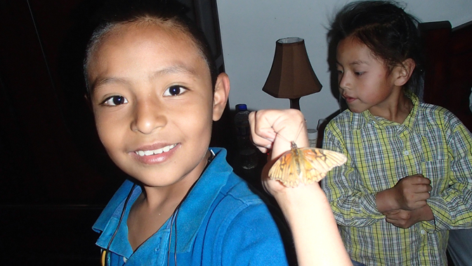 The boys bring a butterfly to Achi Taita