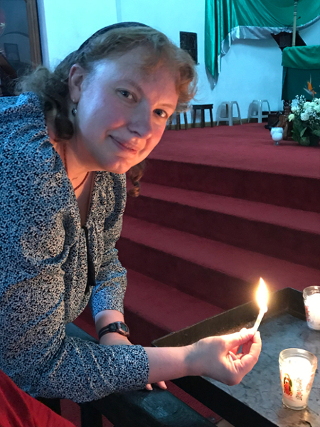 Steph lights a candle for her grandmother at Iglesia San Francisco de Asis, Panajachel