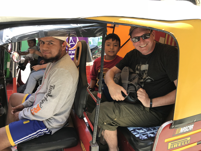 Riding in a tuk-tuk (with Ian Ivan photobomb!)