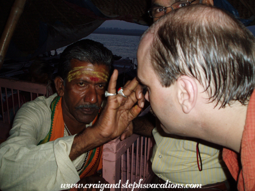 Brahmin applies a tika to Craig's forehead