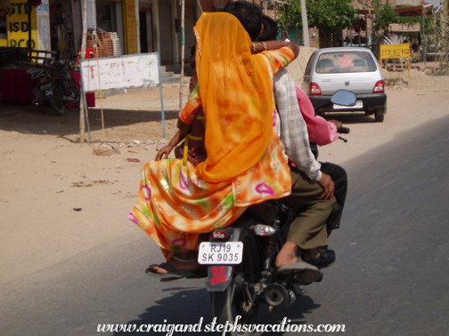 Woman riding on the back of a motorbike