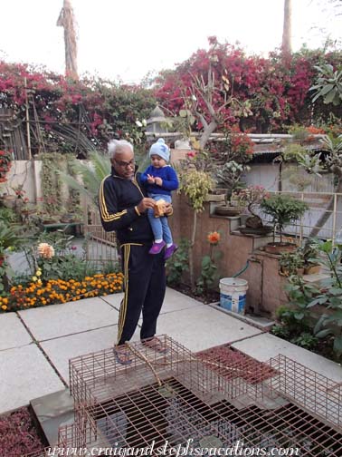 Sara helps Dadoo to feed the fish