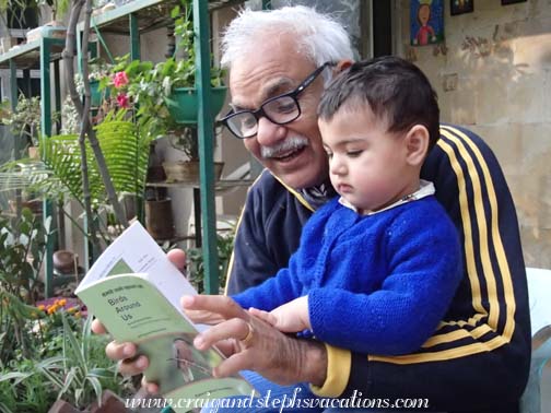 Dadoo and Sara study a bird book