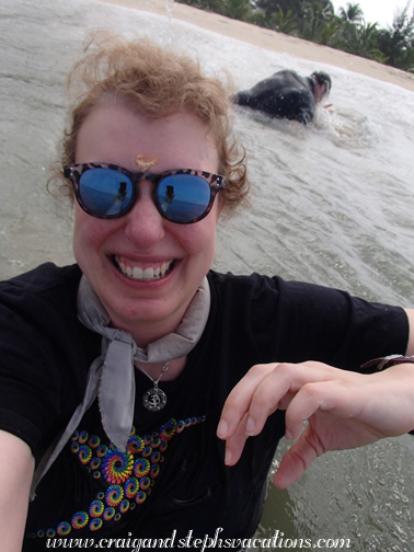 Unbeknownst to Steph, while taking a selfie, a wave washes over Craig