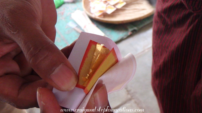 Square of gold leaf which pilgrims apply to pagodas and statues for Buddhist merit-making