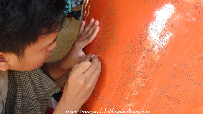 A young man engraves the outline of a pattern onto lacquerware