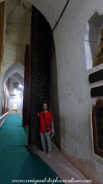 Craig is dwarfed by giant teak doors in Ananda Temple