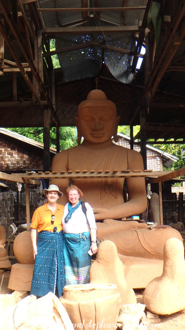 Dwarfed by a large clay Buddha form