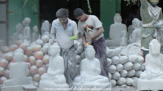 Marble dust flies as craftsmen carve Buddhas