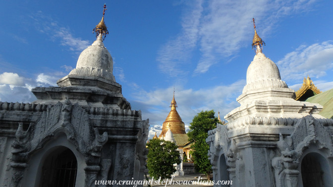 Maha Lawka Marazein Stupa gleams in the sunlight between whitewashed pagodas