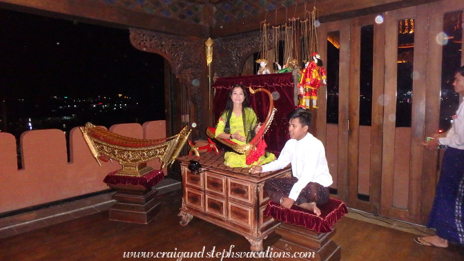 Woman plays a saung (Burmese Harp) at Shwe Bagan Restaurant