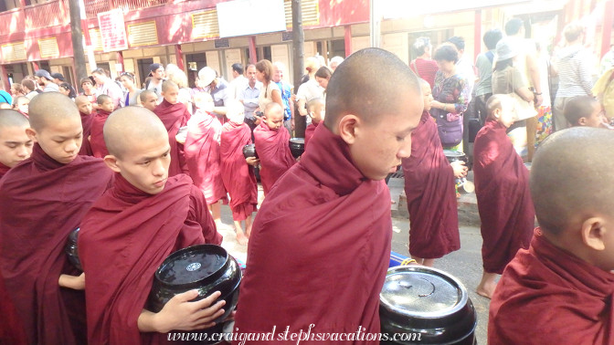 Monks queue for the last meal of the day at Mahagandayon Monastery