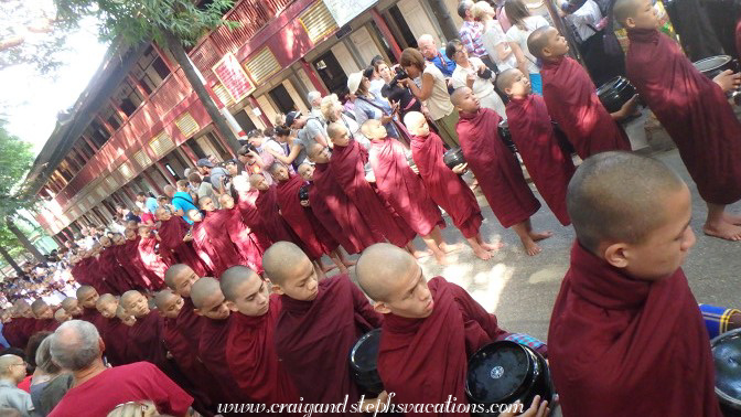 Monks queue for the last meal of the day at Mahagandayon Monastery