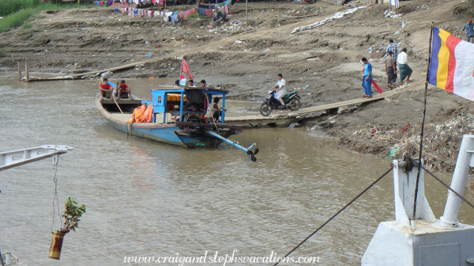 Loading a motorbike onto a small boat