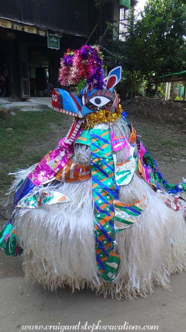 Costumed dancer; part of a procession collecting donations for the elderly