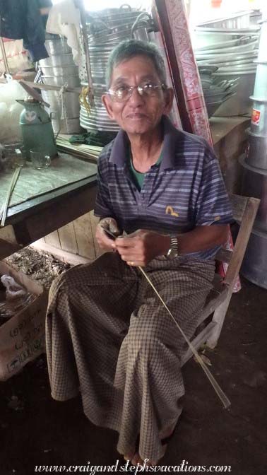 Man carving wooden drums