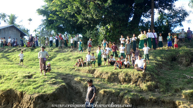 Villagers gather as we approach Tha Phan Seit Village