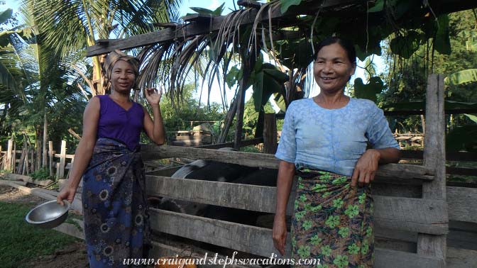 Women feeding the pigs, Tha Phan Seit Village